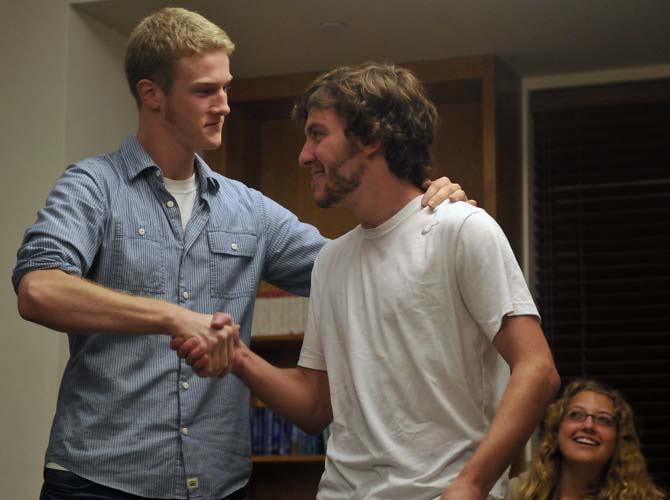 Mechanical Engineer Zachary Barth accepts the award of "Most Rugged Beard" Tuesday, December 3, 2013, at the South Hall Residential College.