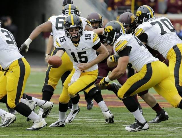 Iowa Hawkeyes quarterback Jake Rudock (15) hands off the ball during the second quarter of an NCAA college football game against Minnesota in Minneapolis Saturday, Sept. 28, 2013. / Ann Heisenfelt/AP