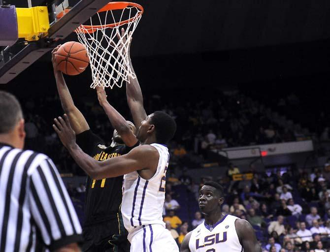 LSU freshman forward Jordan Mickey (25) attempts to block a shot on goal from Southeastern senior forward Antonnio Benton (11) during the Tigers' 89-66 victory against the Lions in the PMAC.