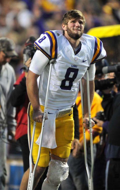 LSU senior quarterback Zach Mettenberger (8) winces in pain after being injured Friday, Nov. 29, 2013 during the Tigers' 31-27 victory against Arkansas at Tiger Stadium.