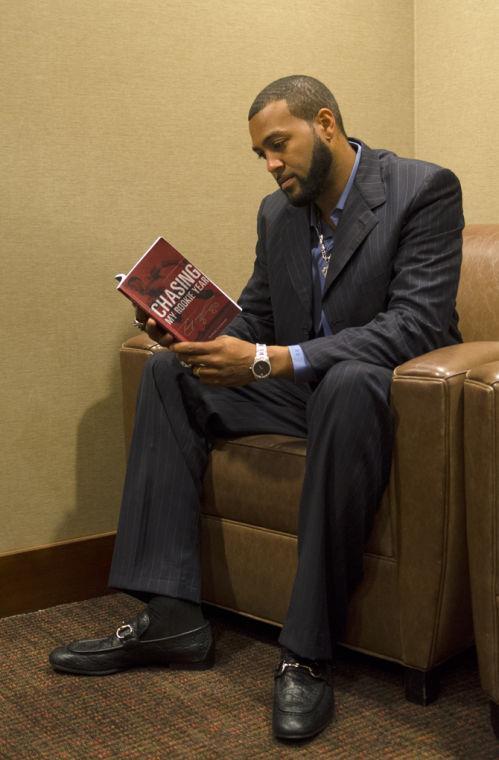 Michael Clayton, former LSU football player, sitting while reminiscing through the pages of his book "Chasing My Rookie Year" the night before his book signing in Baton Rouge.