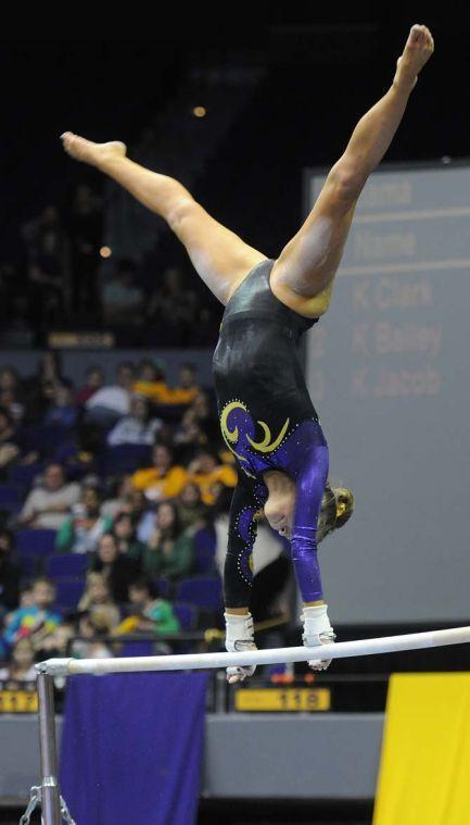 LSU junior all-around gymnast Jessie Jordan swings around the uneven bars Friday, Jan. 31, 2014 during the Tigers' 197.650-196.825 victory against Alabama in the PMAC.