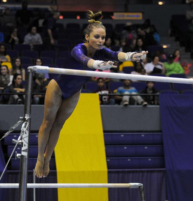 LSU junior all-around Jessie Jordan jumps between uneven bars Friday, Jan. 10, 2014 during the Tigers' 197.2-181.275 victory against Centenary in the PMAC.