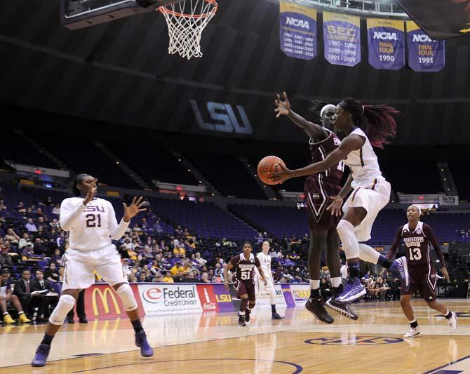 LSU freshman guard Raigyne Moncrief (11) passes tosenior center Shanece McKinney (21) on Thursday, Jan. 30, 2013 during the Lady Tigers' 65-56 victory against Mississippi State in the PMAC.