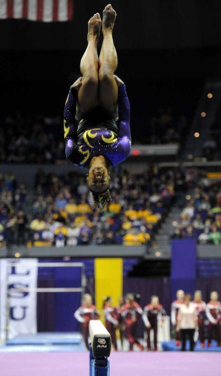 LSU junior all-around gymnast Lloimincia Hall flips off the beam Friday, Jan. 31, 2014 during the Tigers' 197.650-196.825 victory against Alabama in the PMAC.