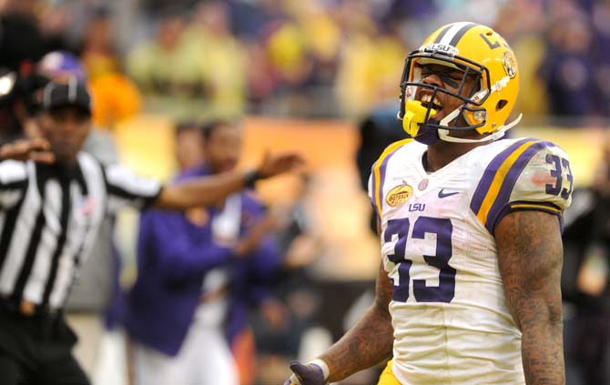 LSU sophomore running back Jeremy Hill (33) celebrates after scoring a touchdown Wednesday, January 1, 2014 during the Tigers' 21-14 victory against Iowa in the Outback Bowl at Raymond James Stadium in Tampa, Florida.