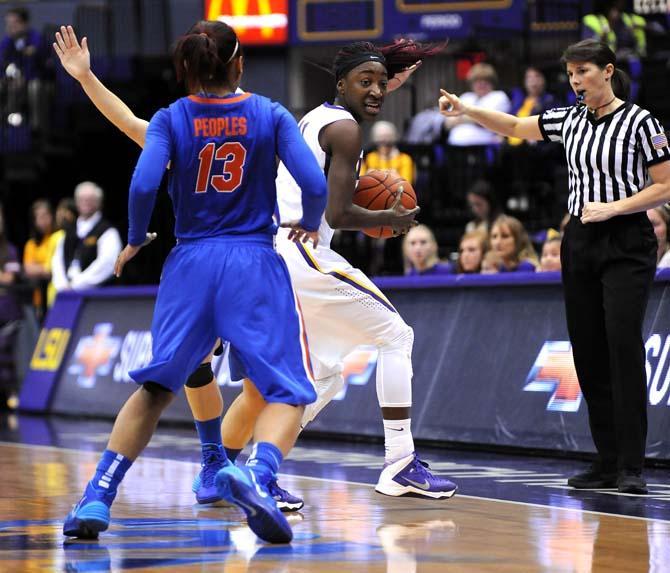 LSU freshman guard Raigyne Moncrief (11) attempts to ward off multiple Florida defenders Sunday, Jan. 12, 2014 during the Tigers 82-68 victory against the Gators in the PMAC.