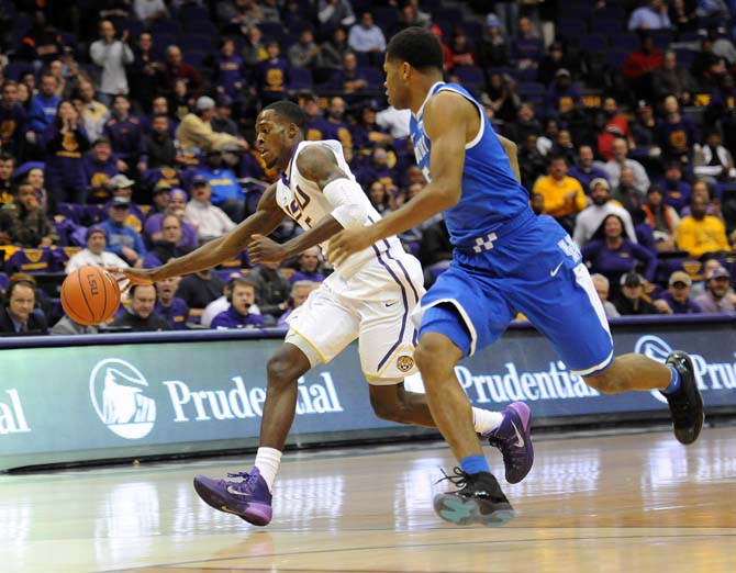 LSU senior forward Shavon Coleman (5) dribbles past a Kentucky defender Tuesday, Jan. 28, 2014, during the Tigers' 87-82 win over the Wildcats in the PMAC. Coleman finished the night with 14 points and nine rebounds.