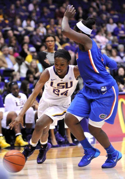 LSU junior guard DaShawn Harden (24) attempts to navigate around a Florida defender Sunday, Jan. 12, 2014 during the Tigers' 83-68 victory against the Gators in the PMAC.