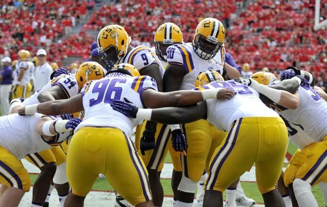 LSU junior defensive tackles Ego Ferguson (9) and Anthony Johnson (90) get their teammates ready for the game Saturday, Sept 28, 2013 before UGA's 44-41 victory against the Tigers in Sanford Stadium.