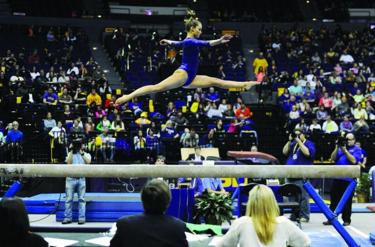 LSU junior all-around Jessie Jordan jumps on the balance beam Friday, Jan. 10, 2014 during the Tigers' 197.2-181.275 victory against Centenary in the PMAC.