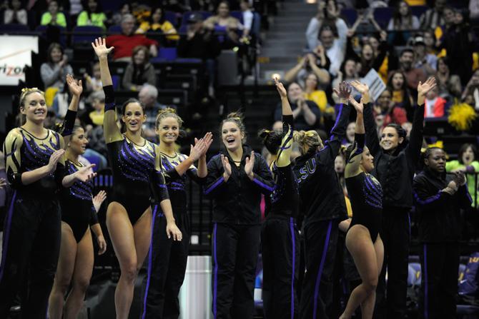 LSU Gymnastics team cheers as they are announced victorious against Auburn with a score of 197.175 to 196.850 on 1.25.14 at the PMAC.