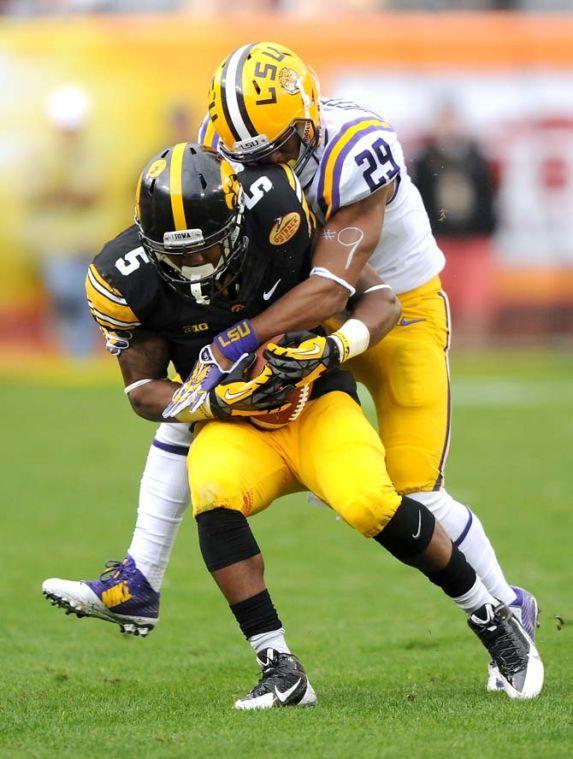 LSU freshman safety Rickey Jefferson (29) attempts to bring down Iowa senior defensive back Tanner Miller (5) Wednesday, January 1, 2014 during the Tigers' 21-14 victory against the Hawkeyes in the Outback Bowl at Raymond James Stadium in Tampa, Florida.