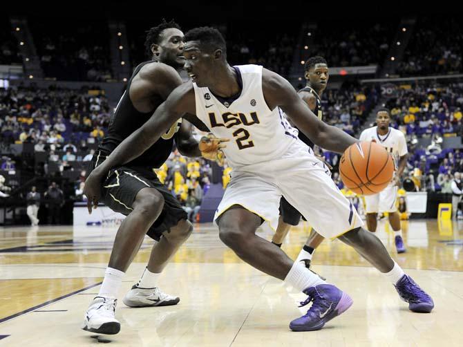 LSU junior forward Johnny O'Bryant III (2) attempts to move the ball past a Vanderbilt defender Saturday, Jan. 18, 2014 during the Tigers' 81-58 victory against the Commodores in the PMAC.