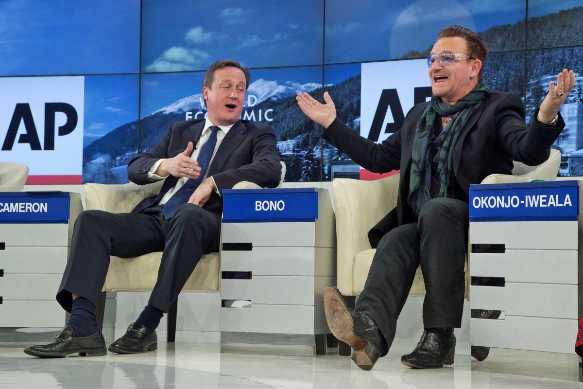 British Prime Minister David Cameron and rock star Bono speak during the panel discussion "The Post-2015 Goals: Inspiring a New Generation to Act", the fifth annual Associated Press debate, at the World Economic Forum in Davos, Switzerland, Friday, Jan. 24, 2014. (AP Photo/Michel Euler)