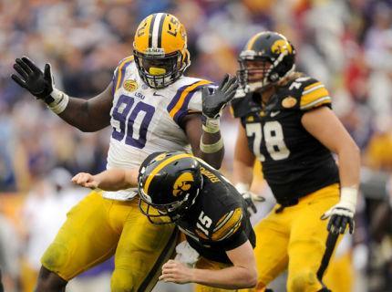 LSU junior defensive tackle Anthony Johnson (90) delivers a hit to Iowa sophomore quarterback Jack Rudock (15) on Wednesday, Jan. 1, 2014 during the Tigers' 21-14 victory against the Iowa Hawkeyes in the Outback Bowl at Raymond James Stadium in Tampa, Florida.