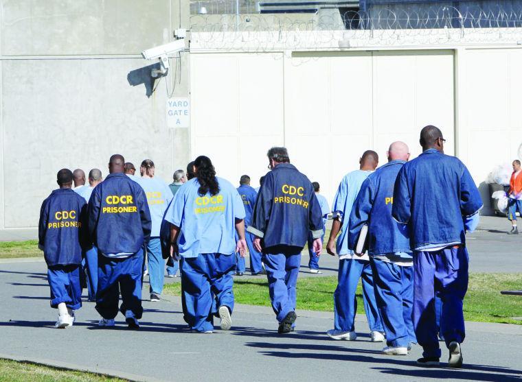 FILE -- In this photo Feb. 26, 2013 file photo, inmates walk through the exercise yard at California State Prison Sacramento, near Folsom, Calif. California's recidivism rate dropped in the years before Gov. Jerry Brown's 2011 realignment law took effect, according to a report released by the California Department of Corrections and Rehabilitation, Wednesday, Jan. 15, 2014.(AP Photo/Rich Pedroncelli, file)