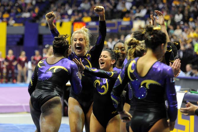 LSU senior all-around gymnast Sarie Morrison celebrates with teammate Lloimincia Hall after her routine on the beam Friday, Jan. 31, 2014 during the Tigers' 197.650-196.825 victory against Alabama in the PMAC.