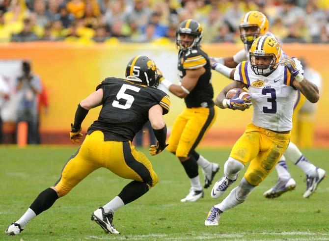 LSU junior wide receiver Odell Beckham Jr. (3) attempts to navigate around an Iowa defender Wednesday, January 1, 2014 during the Tigers' 21-14 victory against the Hawkeyes in the Outback Bowl at Raymond James Stadium in Tampa, Florida.