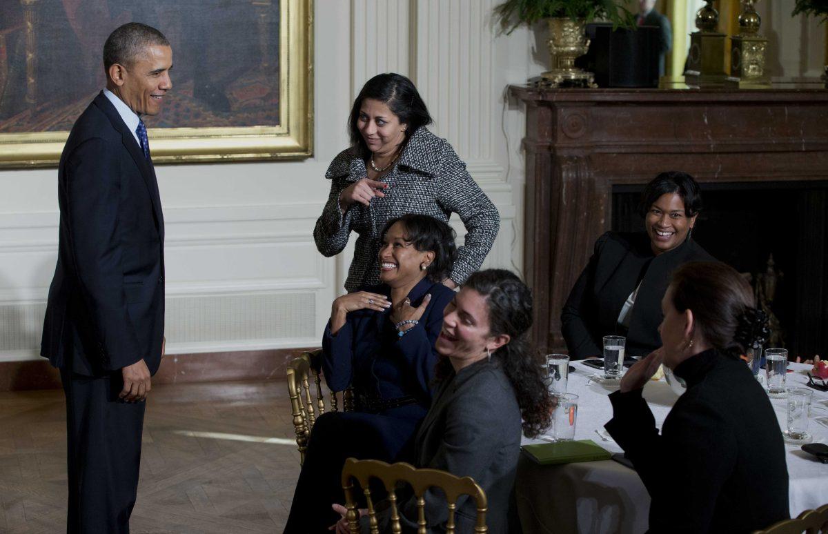 President Barack Obama laughs with women in the East Room of the White House in Washington, Wednesday, Jan. 22, 2014, as he leaves an event for the Council on Women and Girls, where he signed a memorandum creating a task force to respond to campus rapes. (AP Photo/Carolyn Kaster)