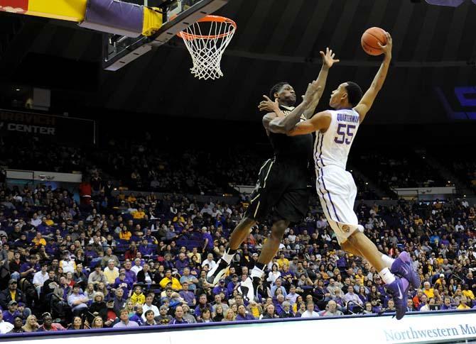 LSU freshman guard Tim Quarterman (55) reaches above a Vanderbilt defender as he heads for the basket Saturday, Jan. 18, 2014 during the Tigers' 81-58 victory against the Commodores in the PMAC.