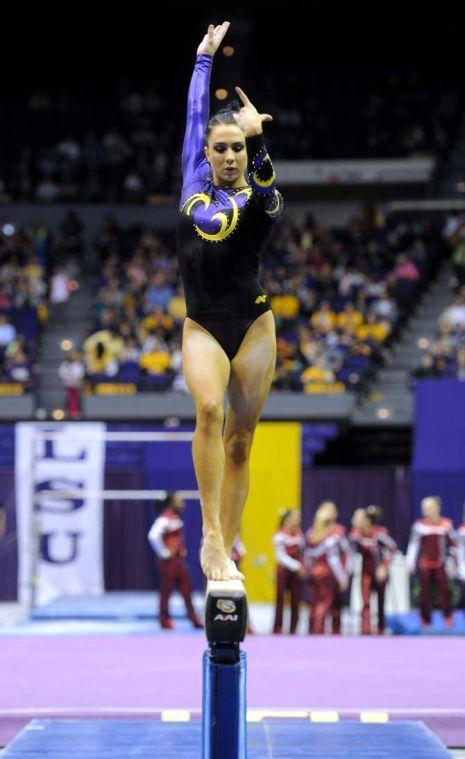 LSU junior all-around gymnast Rheagan Courville poses on the beam Friday, Jan. 31, 2014 during the Tigers' 197.650-196.825 victory against Alabama in the PMAC.