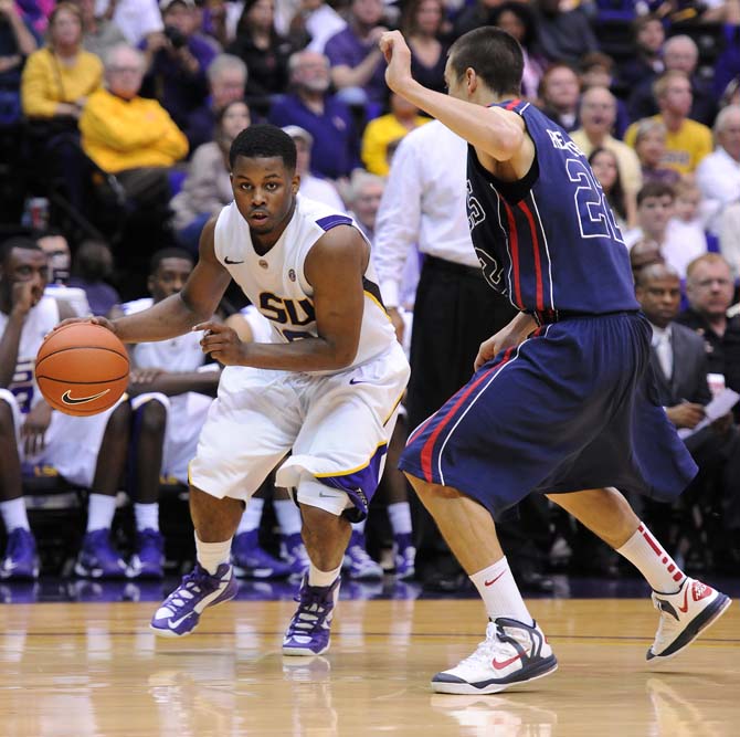 LSU junior guard Andre Stringer (10) drives past Ole Miss junior guard Marshall Henderson (22) during the Tigers' 67-81 loss to the Rebels in the PMAC.