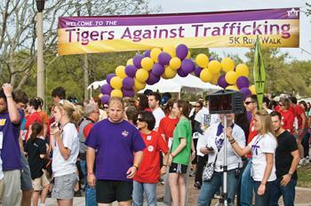 Runners assemble at the starting line Saturday afternoon for the Tigers Against Trafficking 5K Run/Walk event at the Parade Ground.