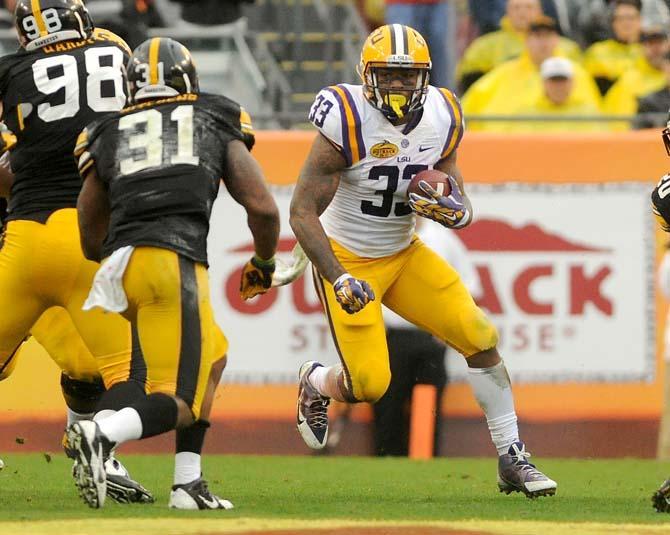 LSU sophomore running back Jeremy Hill (33) attempts to run for a first down Wednesday, Jan. 1, 2014 during the Tigers' 21-14 victory against the Iowa Hawkeyes in the Outback Bowl at Raymond James Stadium in Tampa, Florida.