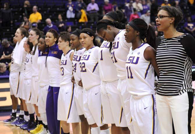 LSU head coach Nikki Caldwell and the members of the Lady Tigers basketball team sing the alma mater Sunday, Jan. 12, 2014 after the Tigers' 82-68 victory against Florida in the PMAC.