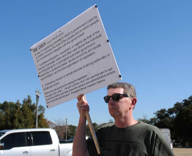 Keith Edwards holds a sign at the Gun Rights Across America rally Sunday, Jan. 19, 2014 in front of the Louisiana state capitol building.