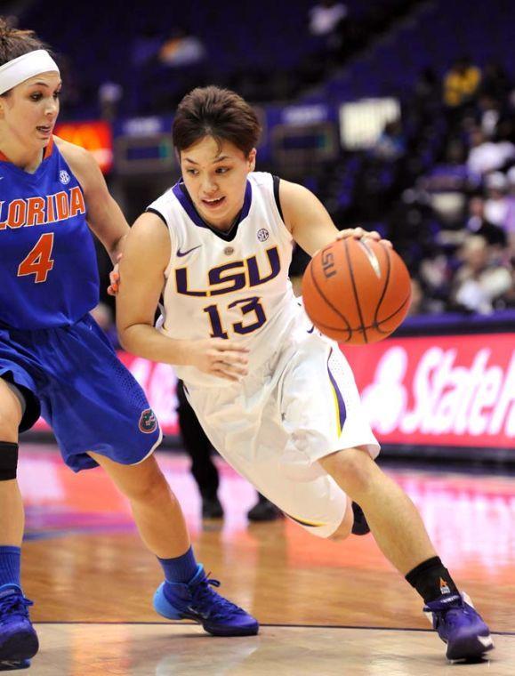 LSU freshman guard Rina Hill (13) moves around Florida sophomore guard Carlie Needles (4) Sunday, Jan.12, 2014 during the Tigers' 82-68 victory against the Gators in the PMAC.