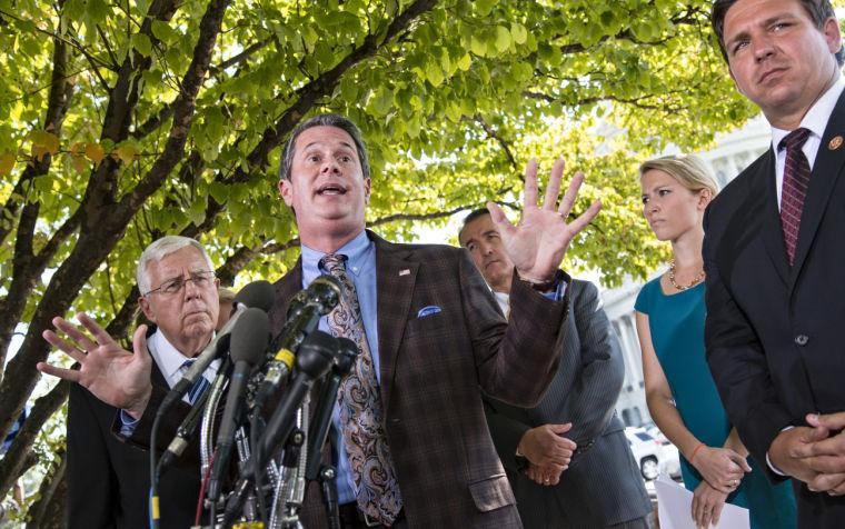 FILE - In this Sept. 30, 2013 file photo, Sen. David Vitter, R-La., speaks to reporters regarding the Affordable Health Care Act at the Capitol in Washington. Listening are from left, Sen. Mike Enzi, R-Wyo., Rep. Trent Franks, R-Ariz., Hadley Heath, of the Independent Women's Forum, and Rep. Ron DeSantis, R-Fla. Vitter will be a candidate in Louisiana's 2015 governor's race, announcing his decision Tuesday, Jan. 21, 2014 in an email to supporters. (AP Photo/J. Scott Applewhite, file)