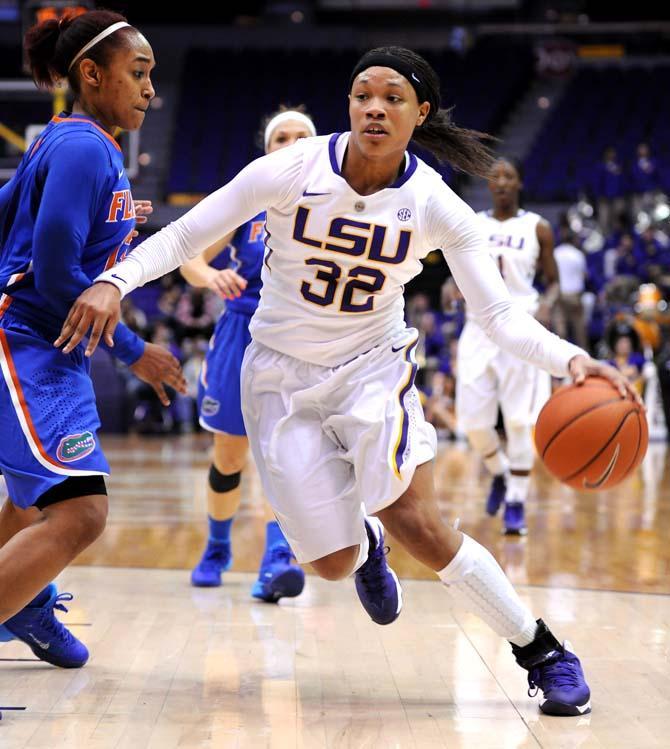 LSU sophomore guard Danielle Ballard (32) cuts toward the net Sunday, Jan. 12, 2014 during the Tigers' 82-68 victory against Florida in the PMAC.