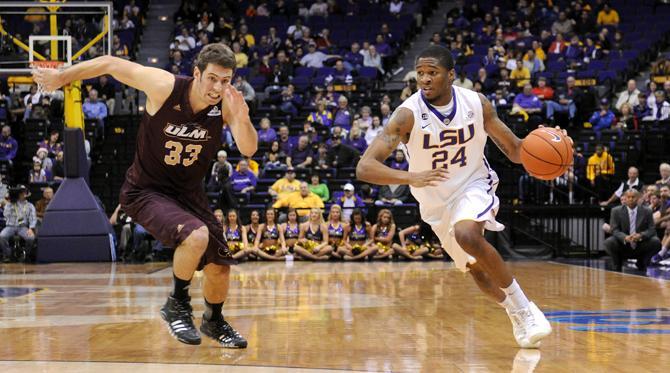 LSU sophomore guard Malik Morgan (24) drives past ULM sophomore guard Daniel Grieves on Dec. 14, 2013 during the Tiger's 61-54 victory against University of Louisiana at Monroe in the PMAC.