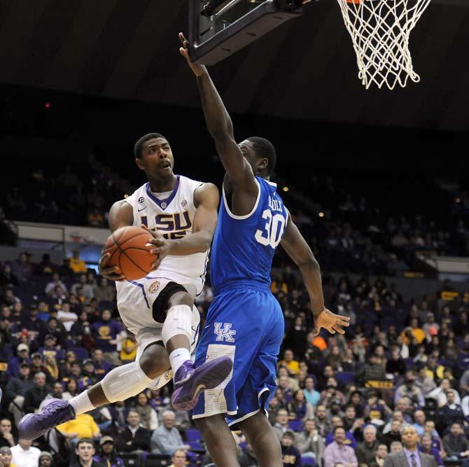 LSU freshman forward Jordan Mickey (25) shoots around Kentucky freshman forward Julius Randle (30) on Tuesday, Jan. 28, 2014 during the Tigers' 87-82 win against the Wildcats in the PMAC.