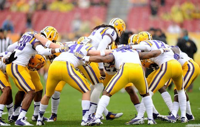 Members of the LSU defense huddle together Wednesday, January 1, 2014 before the Tigers' 21-14 victory against Iowa in the Outback Bowl at Raymond James Stadium in Tampa, Florida.