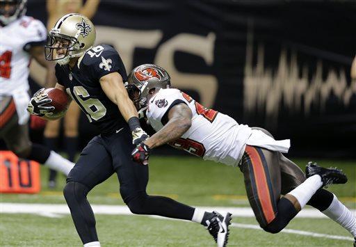 New Orleans Saints wide receiver Lance Moore (16) scores on a touchdown reception as Tampa Bay Buccaneers cornerback Leonard Johnson (29) tries to tackle in the first half of an NFL football game, Sunday, Dec. 29, 2013, in New Orleans. (AP Photo/Bill Haber)