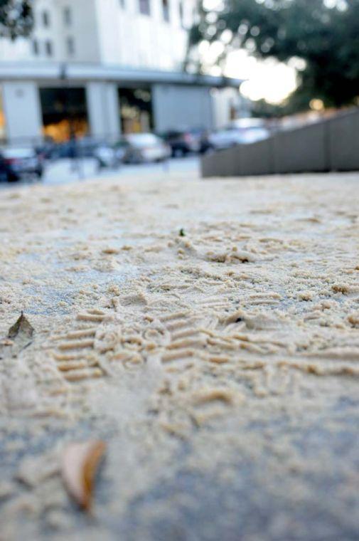 A shoe print is embossed in a pile of sand Thursday, Jan. 30, 2014 outside Hodges Hall near Tiger Stadium. The sand is meant to decrease slipping in the icy weather.