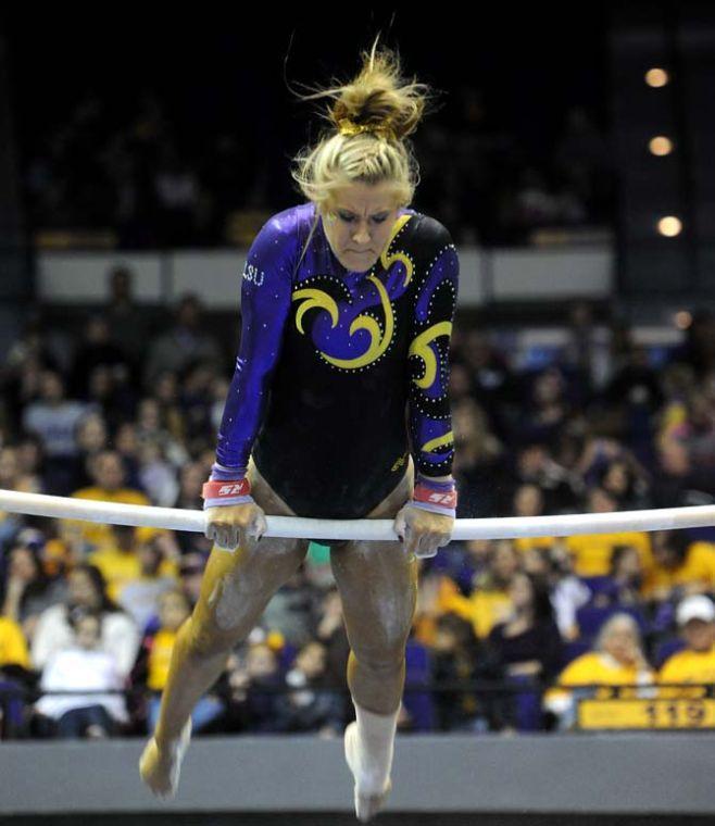 LSU senior all-around gymnast Sarie Morrison swings on the uneven bars Friday, Jan. 31, 2014 during the Tigers' 197.650-196.825 victory against Alabama in the PMAC.