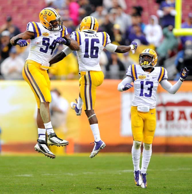 LSU freshman defensive back Tre'Davious White (16) celebrates with teammates sophomore defensive end Danielle Hunter (94) and sophomore defensive back Chris LaBorde (13) after a successful play Wednesday, January 1, 2014 during the Tigers' 21-14 victory against Iowa in the Outback Bowl at Raymond James Stadium in Tampa, Florida.