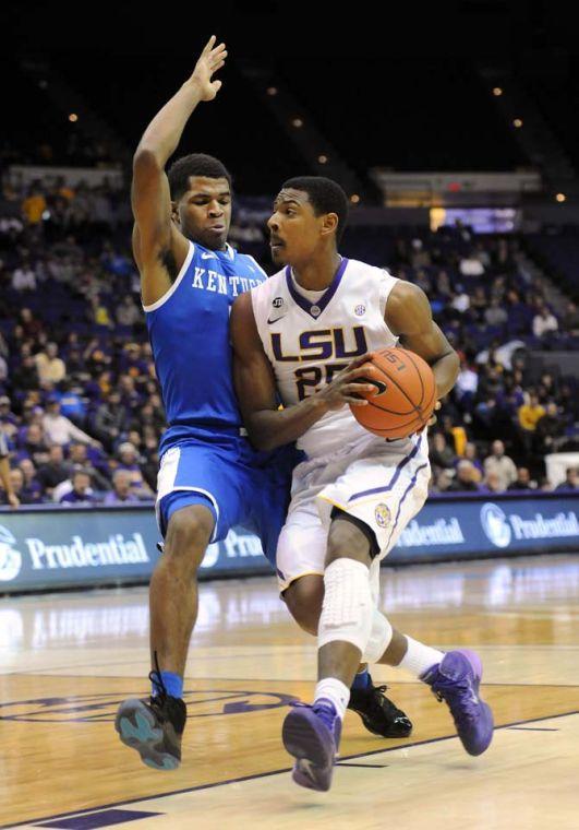 LSU freshman forward Jarell Martin (12) drives past a Kentucky defender Tuesday, Jan. 28, 2014 during the Tigers' 87-82 in the PMAC.