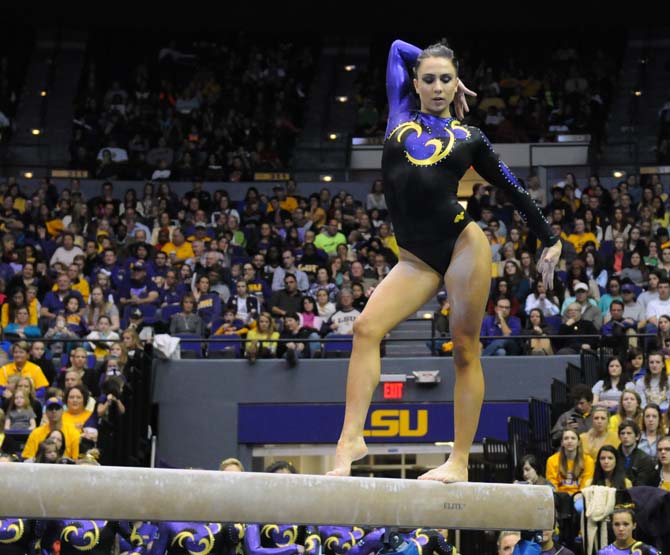 LSU junior all-around gymnast Rheagan Courville poses on the beam Friday, Jan. 31, 2014 during the Tigers' 197.650-196.825 victory against Alabama at the PMAC.