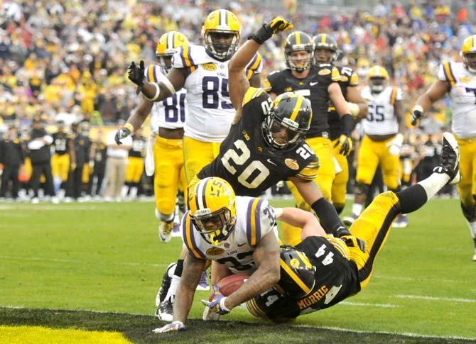 LSU sophomore running back Jeremy Hill (33) fights his way into the endzone Wednesday, January 1, 2014 during the Tigers' 21-14 victory against Iowa in the Outback Bowl at Raymond James Stadium in Tampa, Florida.