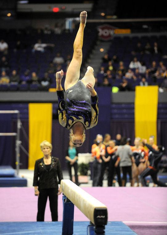 LSU Gymnast, Kaleigh Dickson, backflipping on the balance beam during her routine at the LSU vs Auburn Gym Meet on 1.25.14 in the PMAC.