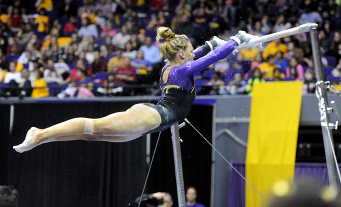 LSU senior all-around gymnast Kaleigh Dickson swings on the uneven bars Friday, Jan. 31, 2014 during the Tigers' 197.650-196.825 victory against Alabama in the PMAC.