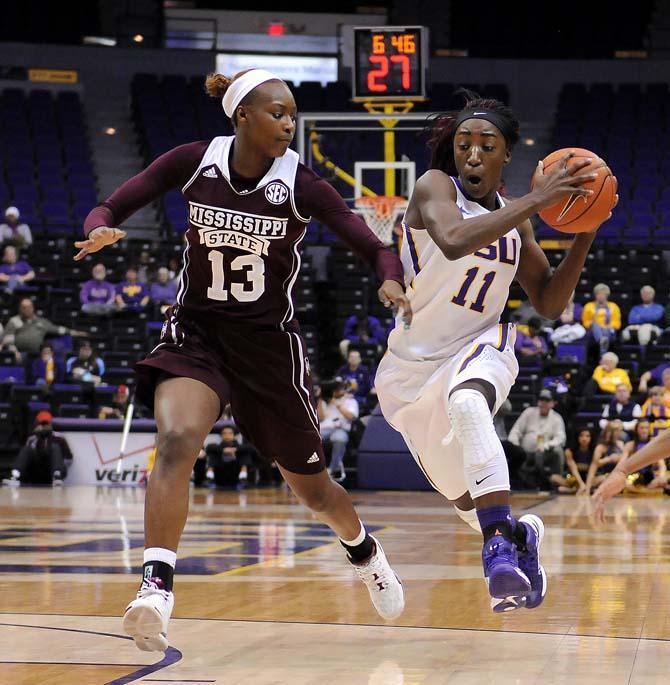 LSU freshman guard Raigyne Moncrief (11) drives past Mississippi State freshman forward Ketara Chapel (13) on Thursday, Jan. 30, 2013 during the Lady Tigers' 65-56 victory against Mississippi State in the PMAC.