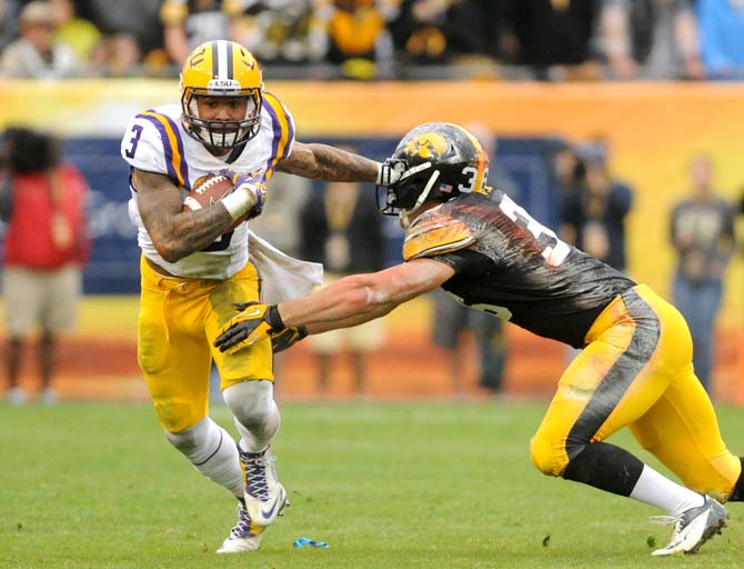 LSU junior wide receiver Odell Beckham Jr. (3) attempts to ward off an Iowa defender Wednesday, January 1, 2014 during the Tigers' 21-14 victory against the Hawkeyes in the Outback Bowl at Raymond James Stadium in Tampa, Florida.