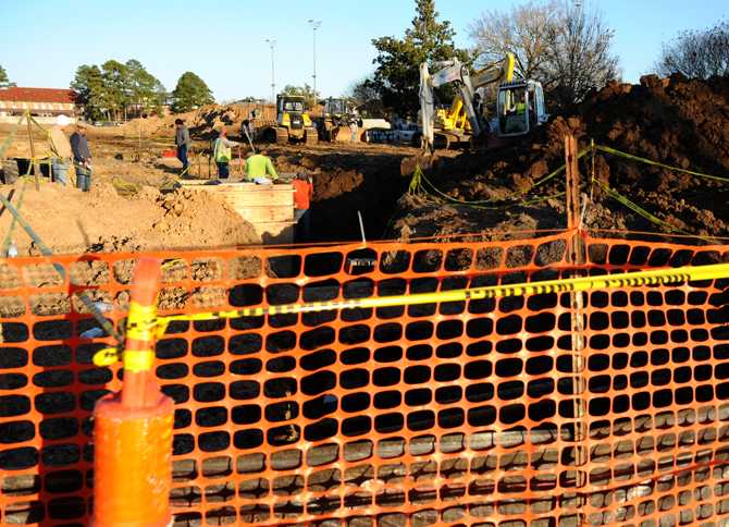 Construction workers updating the UREC fields Thursday, Jan. 16, 2013.