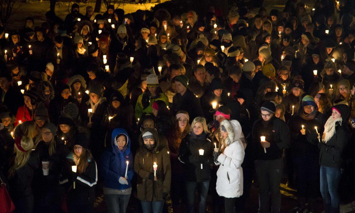 Purdue University students, faculty, family and friends gather at the steps of Hovde Hall for a vigil for a teaching assistant who was fatally shot on campus at Purdue University, on Tuesday, Jan. 21, 2014, in West Lafayette, Ind. The victim was identified as Andrew Boldt, 21, a senior in electrical engineering from Wisconsin who lived on campus, according to Purdue. Another student, Cody Cousins, was arrested on a preliminary charge of murder, athourities said. (AP Photo/The Journal &amp; Courier, Michael Heinz) MANDATORY CREDIT; NO SALES